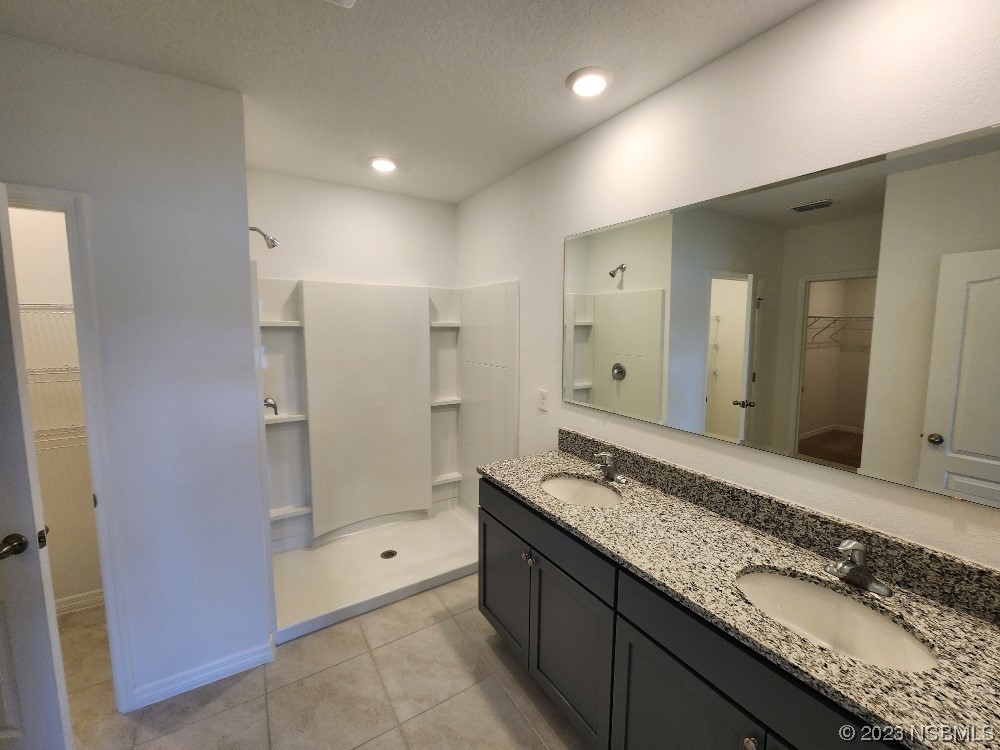 1841 Red Rock Road New Smyrna Beach, FL 32168 - Photo 9 of 22 a bathroom with a granite countertop sink mirror and shower