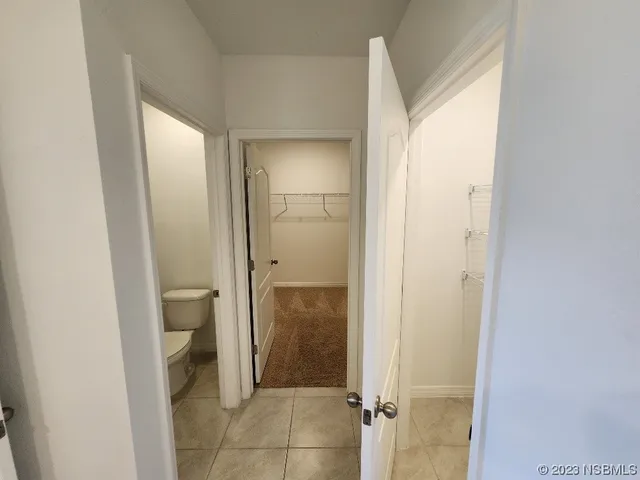 an empty room with closet and windows