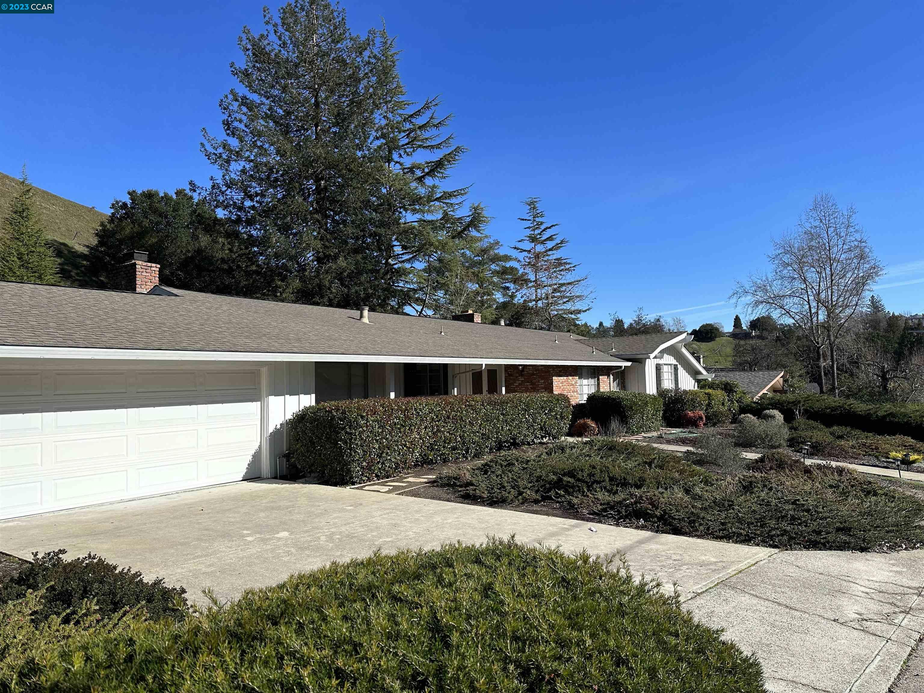 44 Lynwood Place Moraga, CA 94556 - Photo 2 of 12 a front view of house with yard and trees in the background