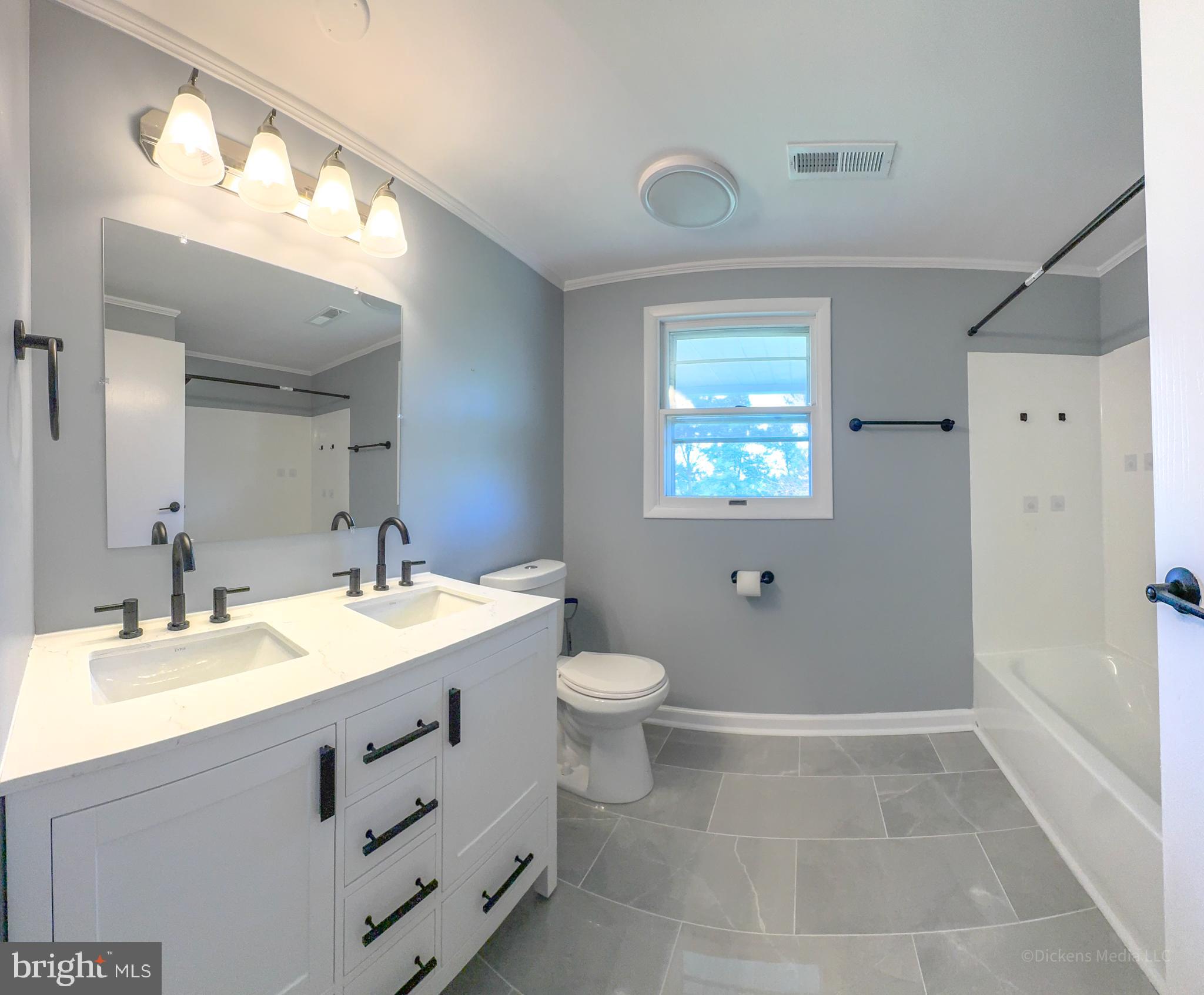 25 John Owings Road Westminster, MD 21158 - Photo 15 of 32 a bathroom with a sink a toilet and shower