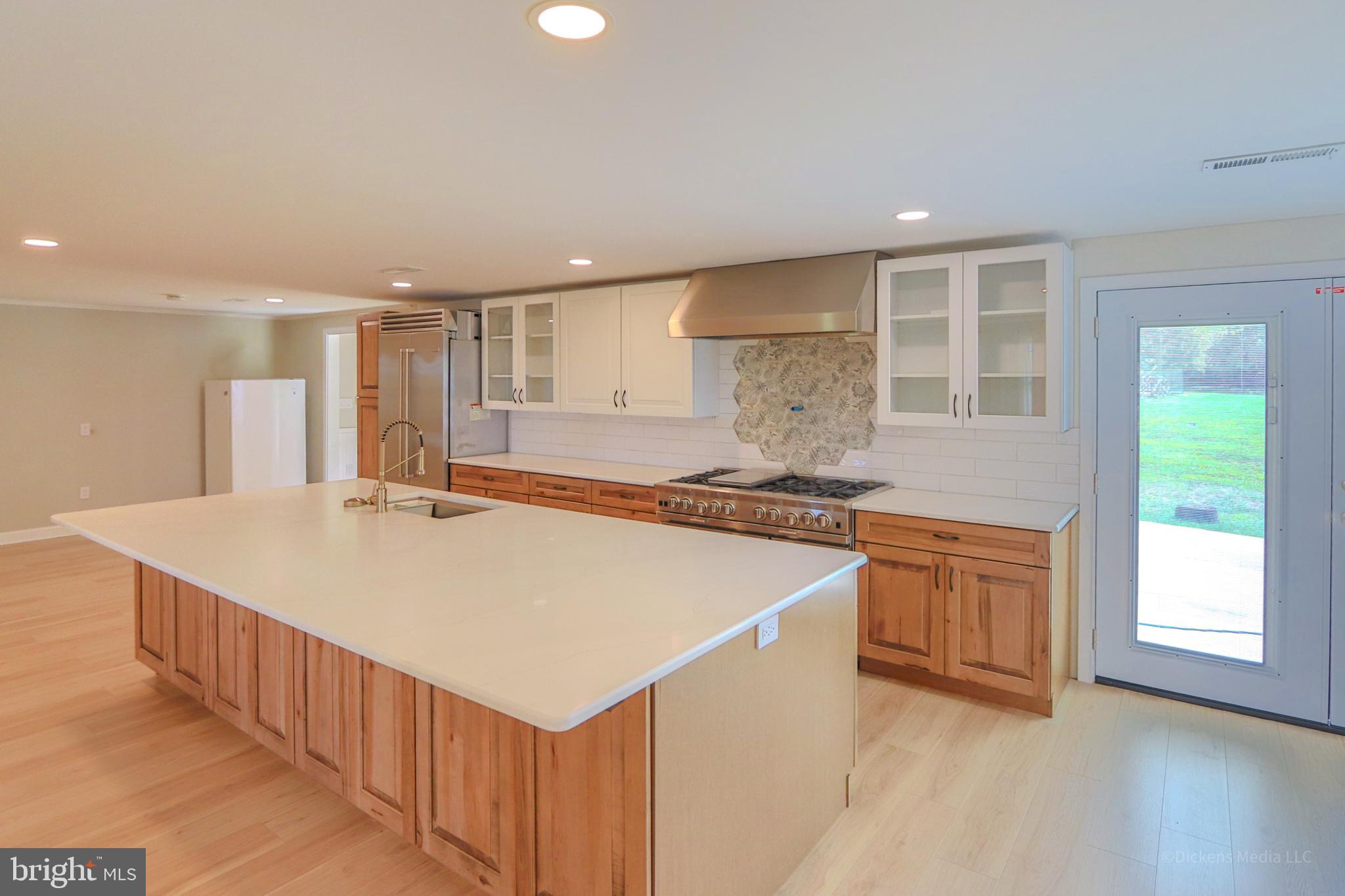 25 John Owings Road Westminster, MD 21158 - Photo 2 of 32 a kitchen with stainless steel appliances granite countertop a sink and a stove