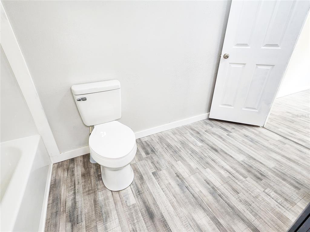 88 North Saturn Avenue Inverness, FL 34453 - Photo 34 of 44 a white toilet sitting next to a white sink and vanity