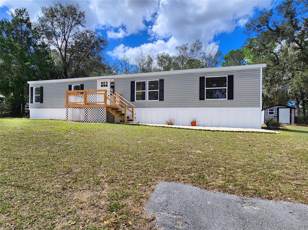 88 North Saturn Avenue Inverness, FL 34453 - Photo 43 of 44 a front view of house with yard and trees in the background