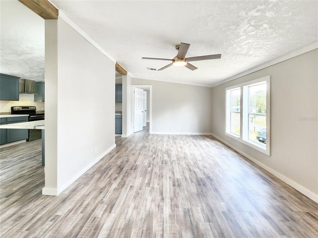 88 North Saturn Avenue Inverness, FL 34453 - Photo 6 of 44 a view of empty room with wooden floor and fan