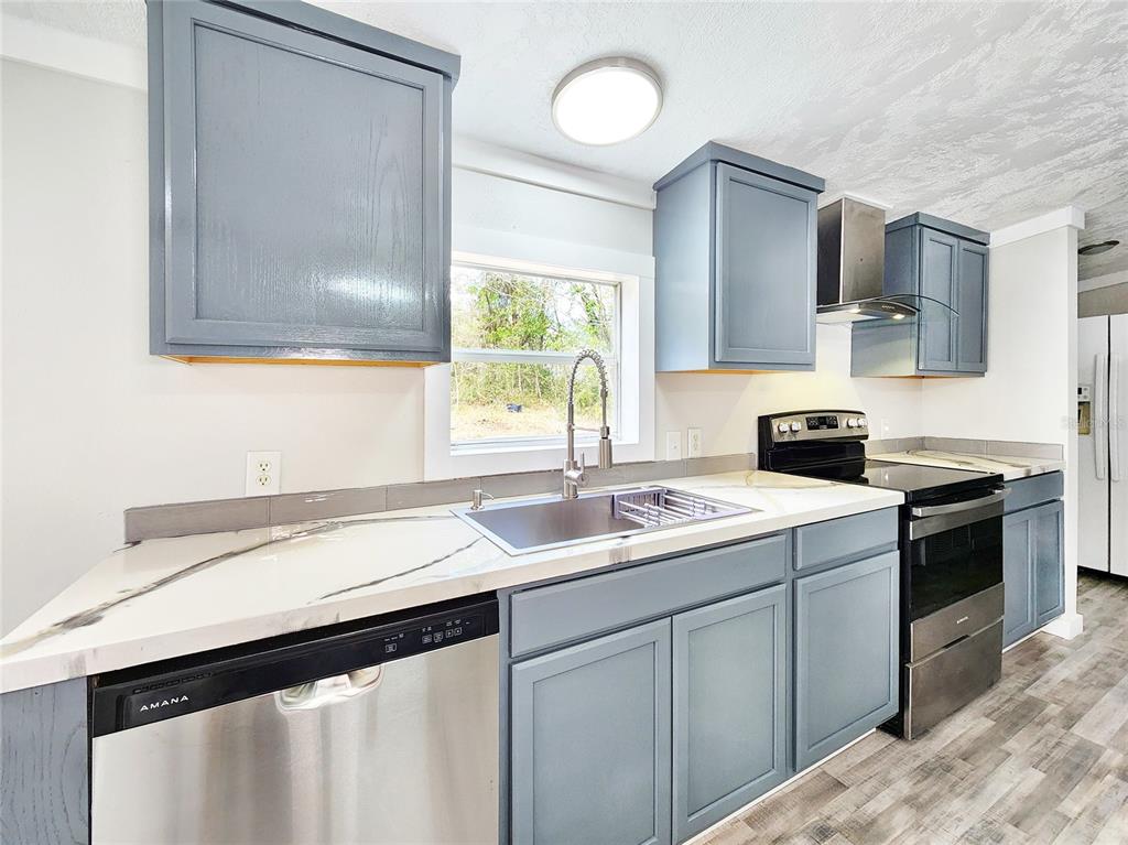 88 North Saturn Avenue Inverness, FL 34453 - Photo 8 of 44 a kitchen with a sink cabinets and a window
