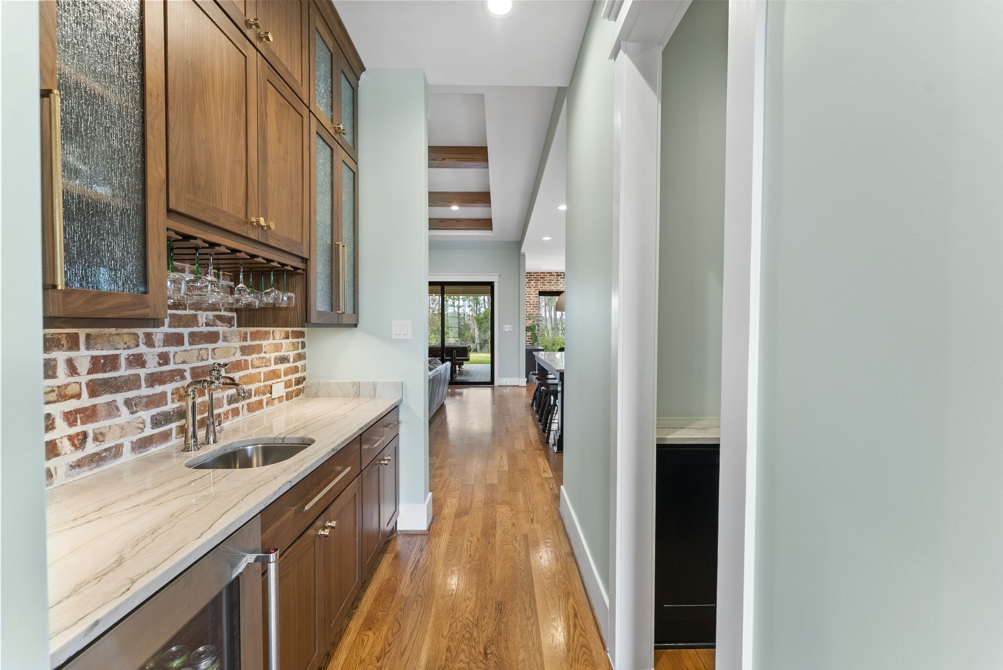 14019 Beartooth Bend Trail Conroe, TX 77384 - Photo 6 of 28 No details missed with custom finishes throughout. Polished nickel fixures, brushed gold hardware, marble countertops, brick backsplash, wine storage, and wet bar perfect for entertaining.