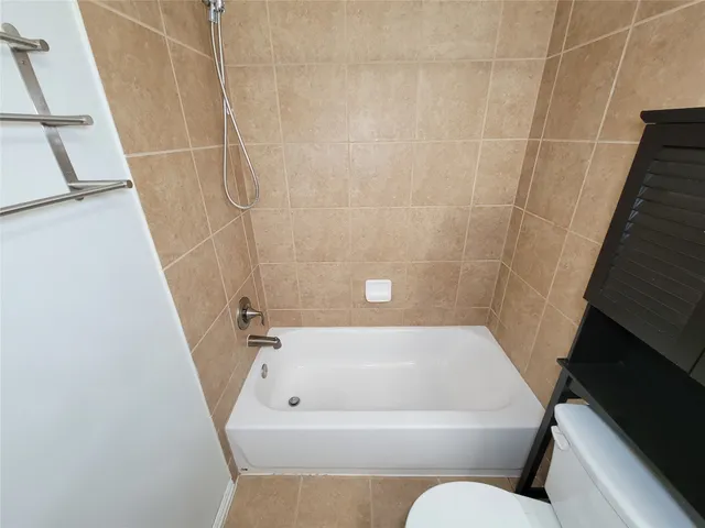 a bathroom with a bathtub and shower