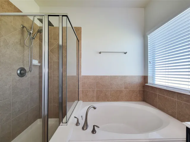a bathroom with a tub and shower
