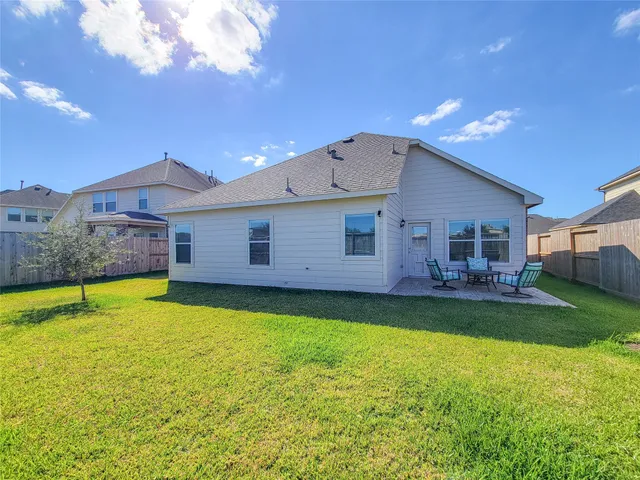 a view of a house with a backyard