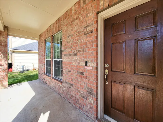 a view of a brick house with a large window