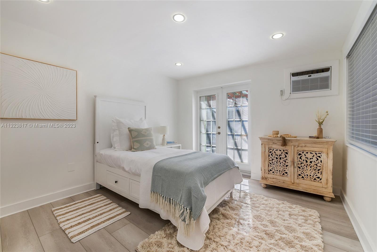 8540 Southwest 124th Street Miami, FL 33156 - Photo 11 of 22 a bedroom with a large bed and a chandelier