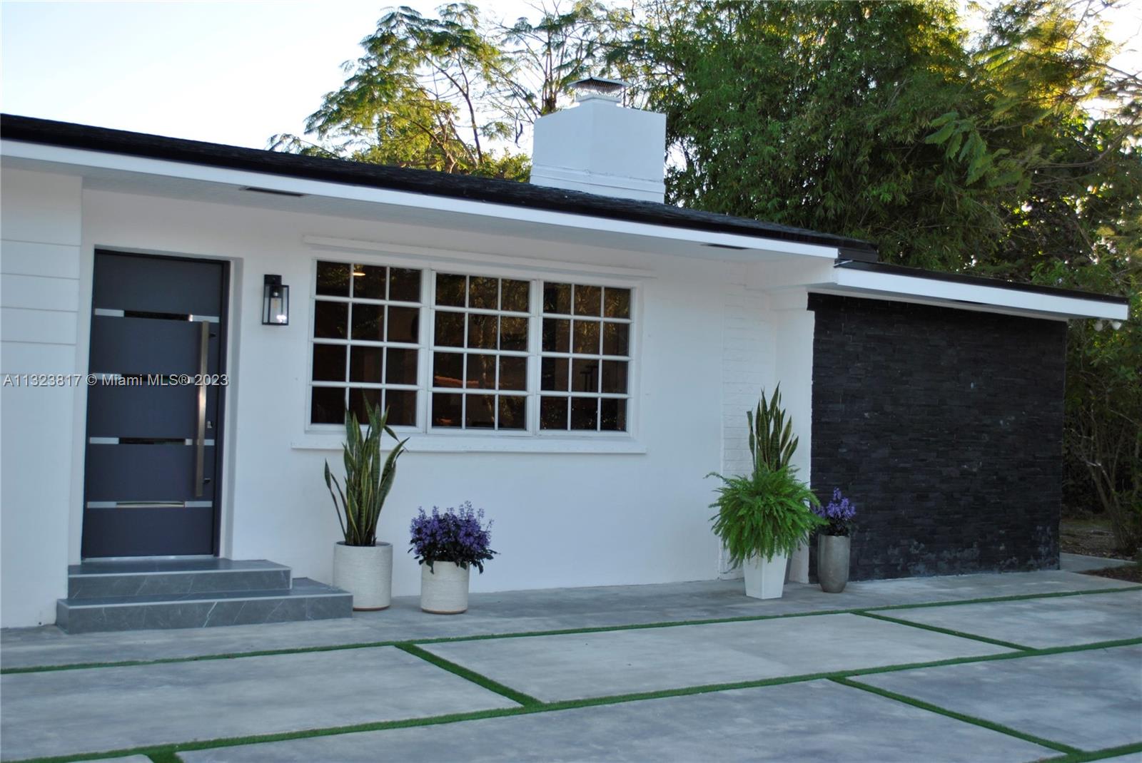 8540 Southwest 124th Street Miami, FL 33156 - Photo 20 of 22 a front view of a house with a yard