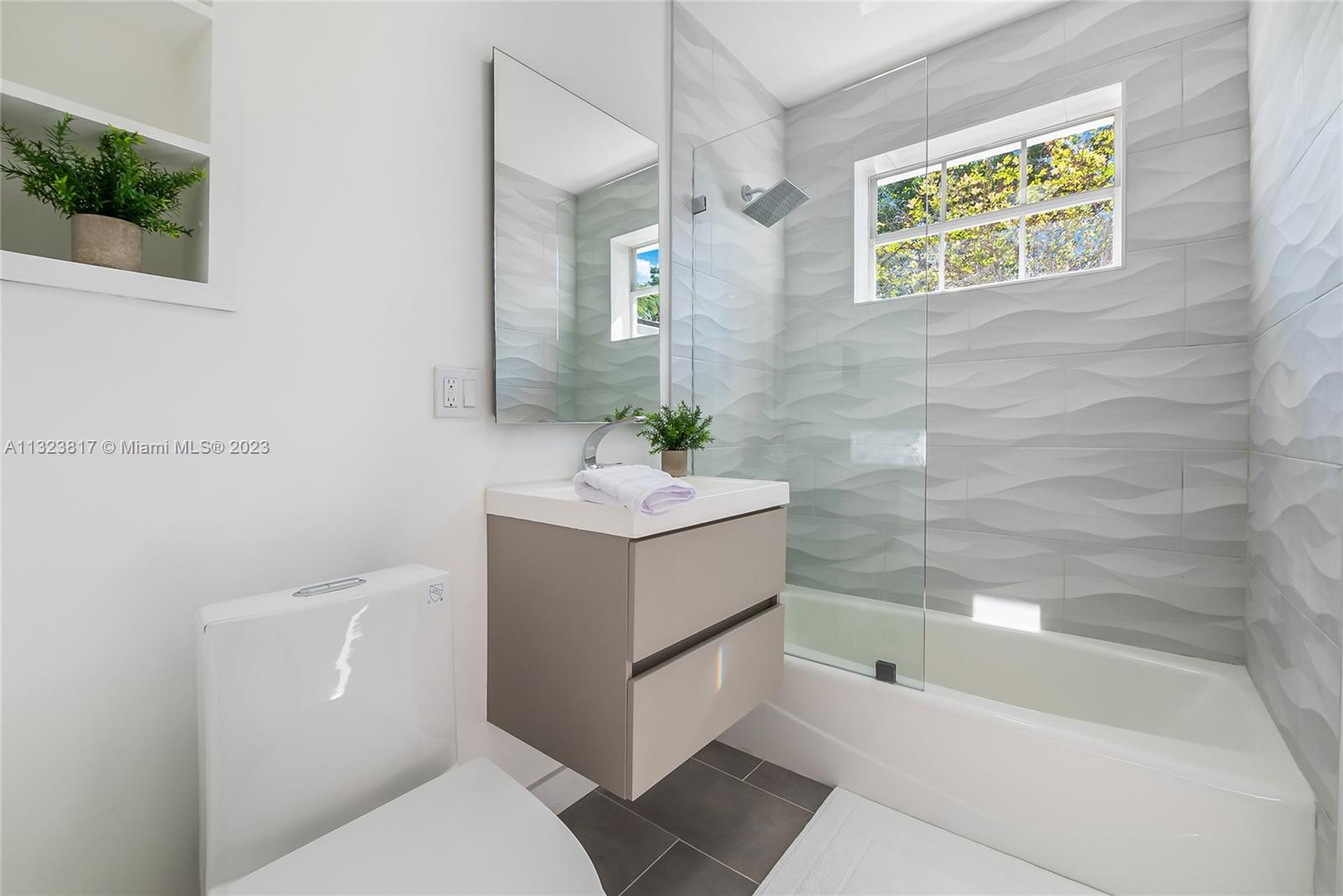 8540 Southwest 124th Street Miami, FL 33156 - Photo 9 of 22 a bathroom with a sink mirror bathtub and toilet