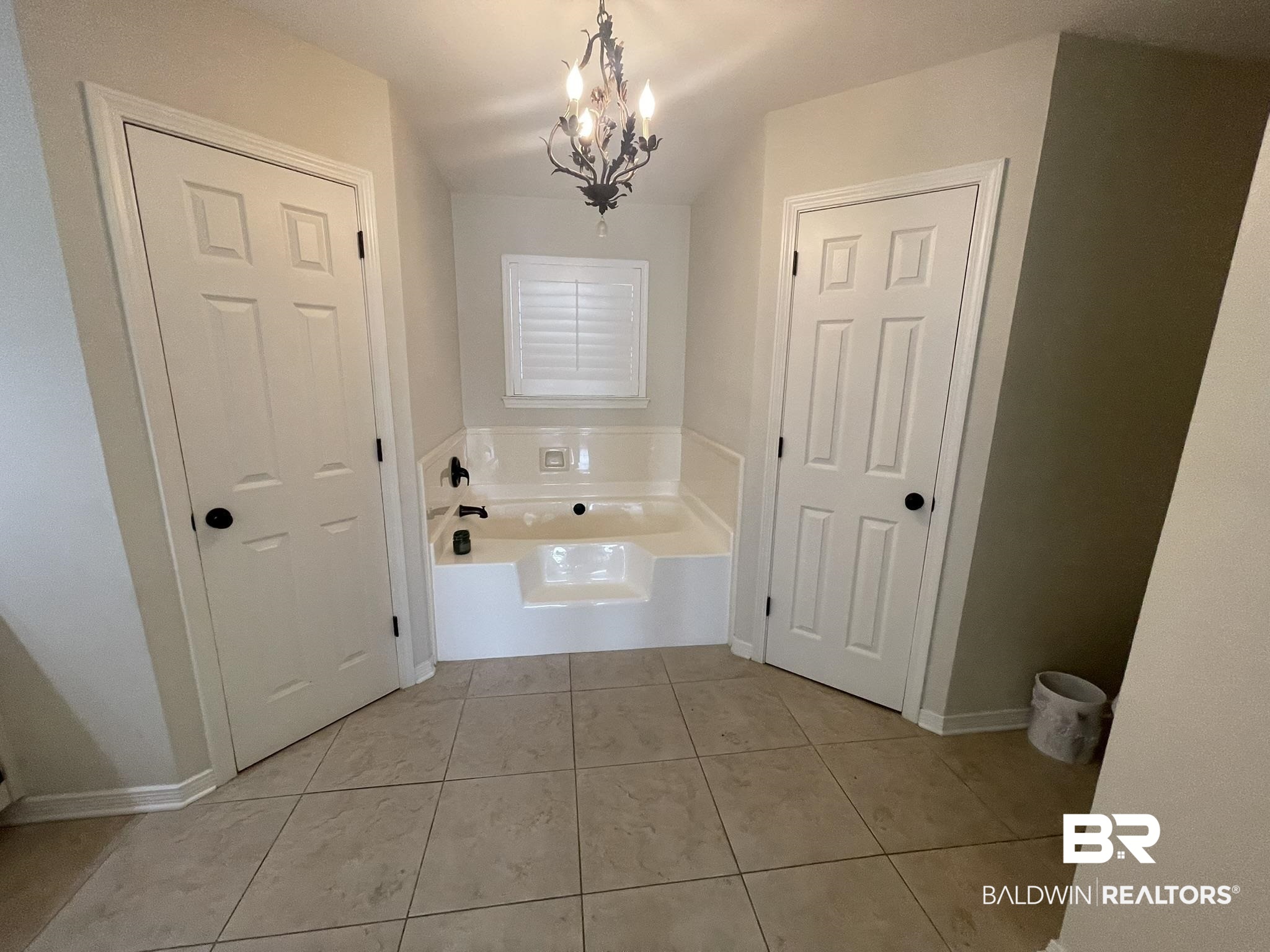 35405 Pine Road South Stapleton, AL 36578 - Photo 15 of 29 Bathroom with a bath, a chandelier, and light tile patterned floors