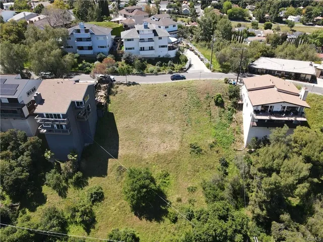 an aerial view of multiple houses with yard