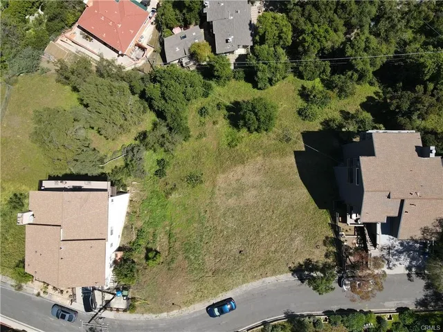 an aerial view of a house with a yard