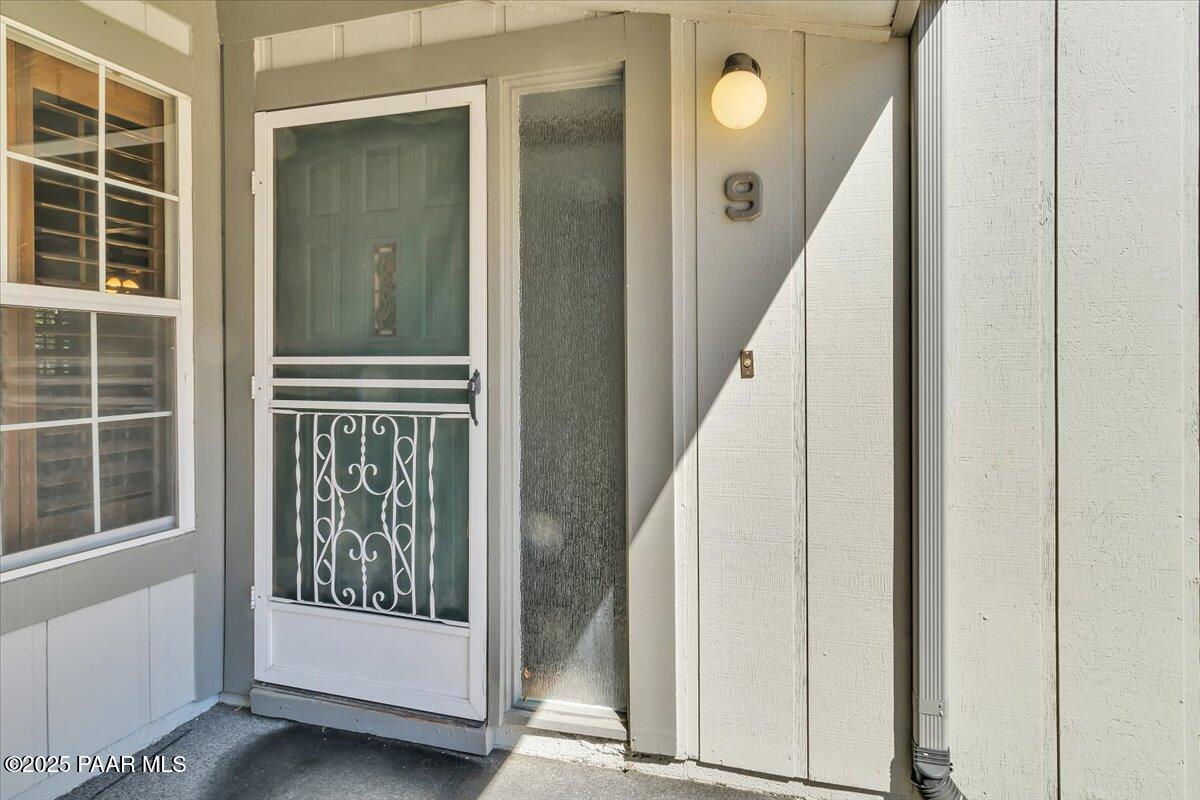 a view of a entryway with wooden floor and windows