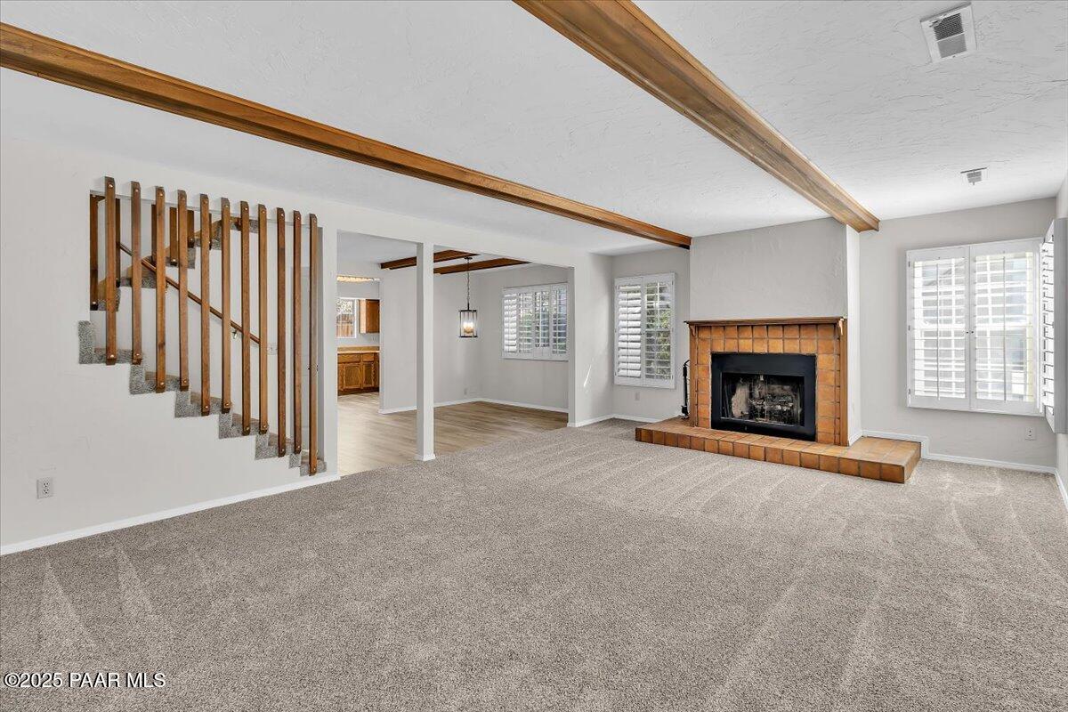345 South Virginia Street, Unit 9 Prescott, AZ 86303 - Photo 6 of 33 a view of an empty room with fireplace and a window