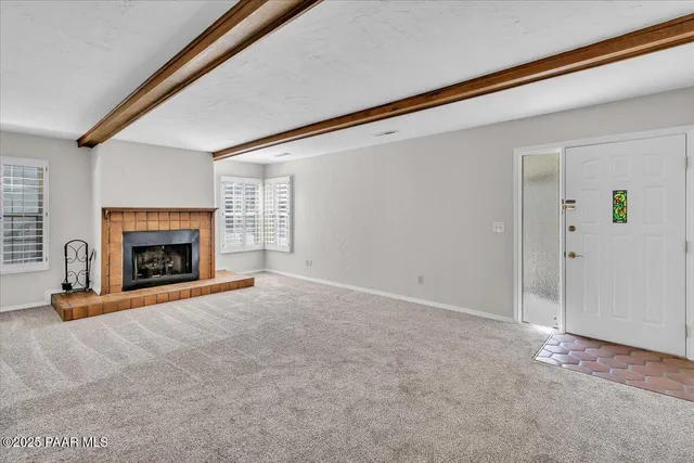 an empty room with a fireplace and painted walls