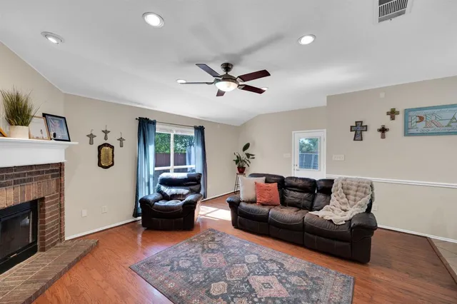 a living room with furniture a fireplace and a flat screen tv