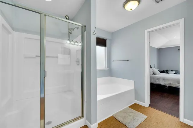 a bathroom with a tub sink and mirror