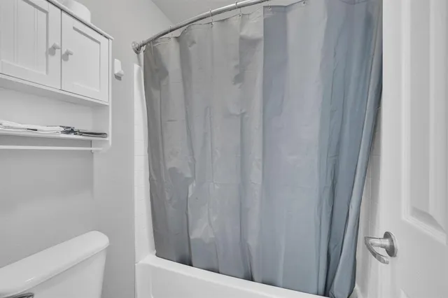 a bedroom with a bed and a ceiling fan