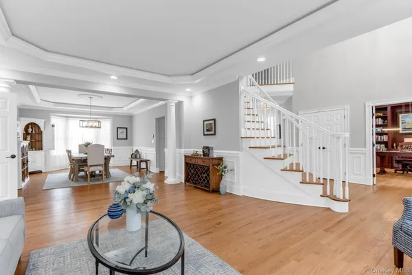 a living room with fireplace furniture and wooden floor