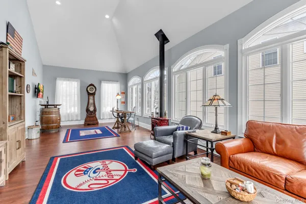 a living room with furniture a rug and a large window