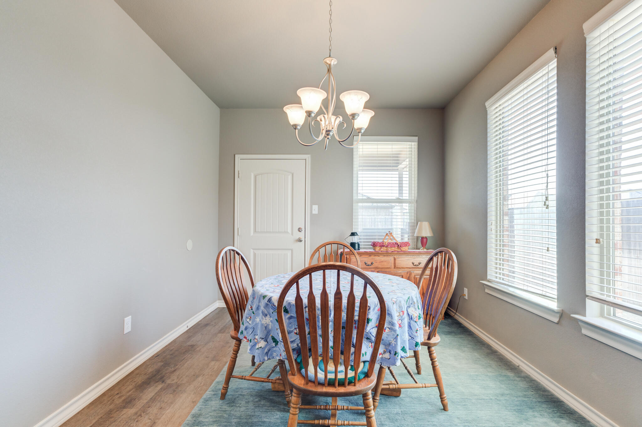 5219 Kemper Street Lubbock, TX 79416 - Photo 19 of 38 a view of a dining room with furniture window and wooden floor