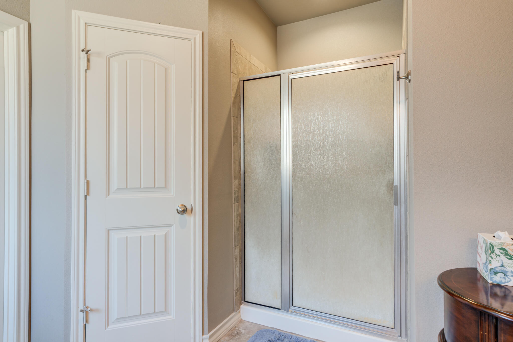5219 Kemper Street Lubbock, TX 79416 - Photo 25 of 38 a bathroom with a glass shower door