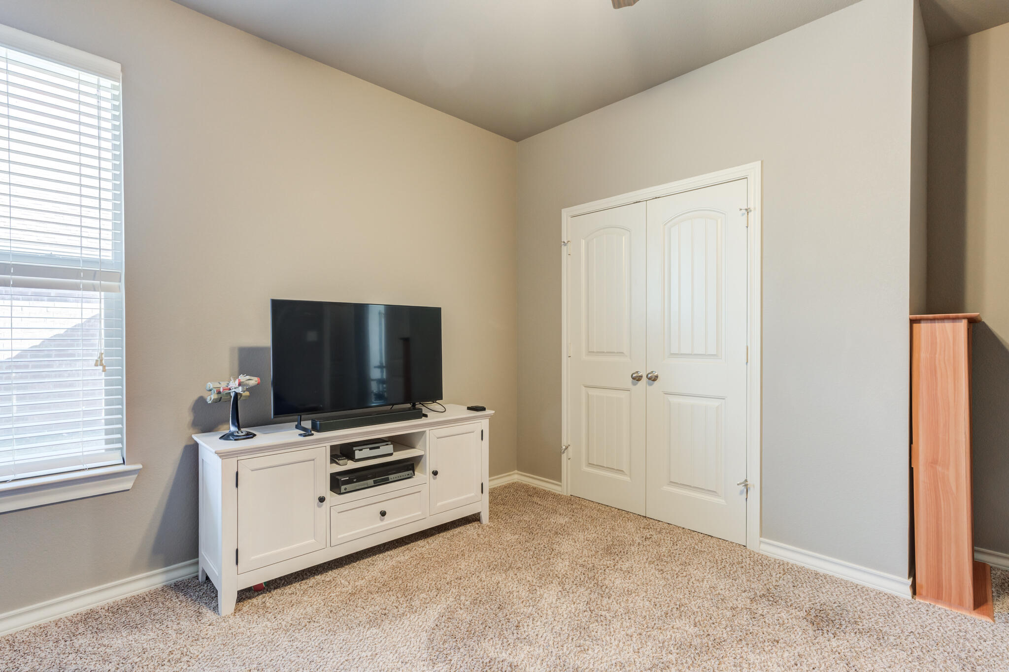 5219 Kemper Street Lubbock, TX 79416 - Photo 30 of 38 a room with furniture and flat screen tv