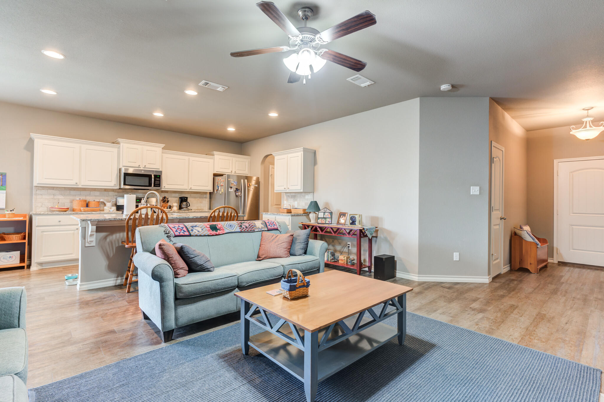 5219 Kemper Street Lubbock, TX 79416 - Photo 3 of 38 a living room with furniture and kitchen view