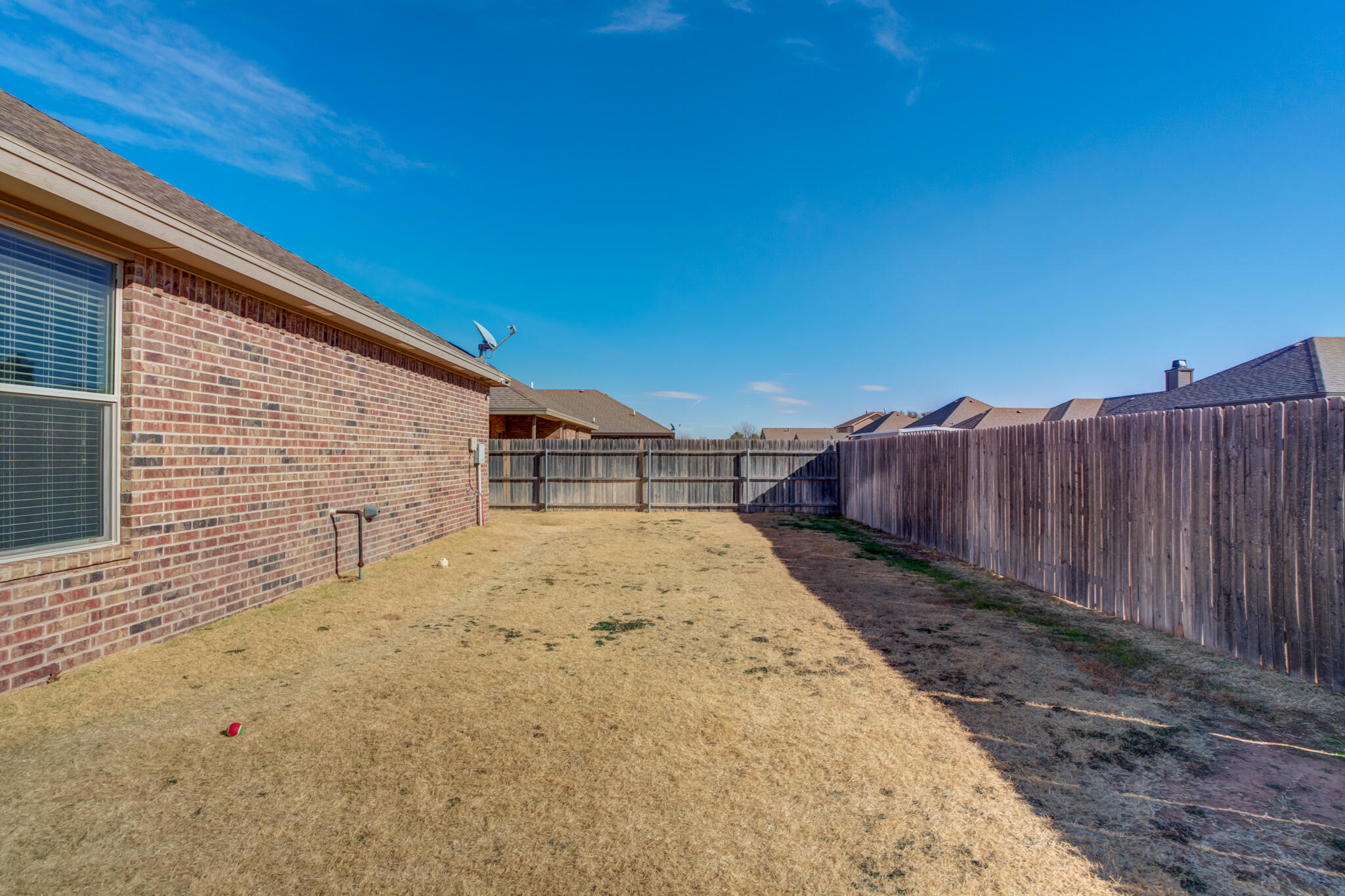 5219 Kemper Street Lubbock, TX 79416 - Photo 37 of 38 a view of a backyard with wooden fence