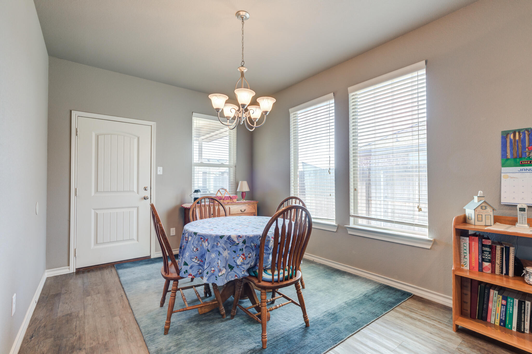 5219 Kemper Street Lubbock, TX 79416 - Photo 4 of 38 a view of a dining room with furniture and a book shelf