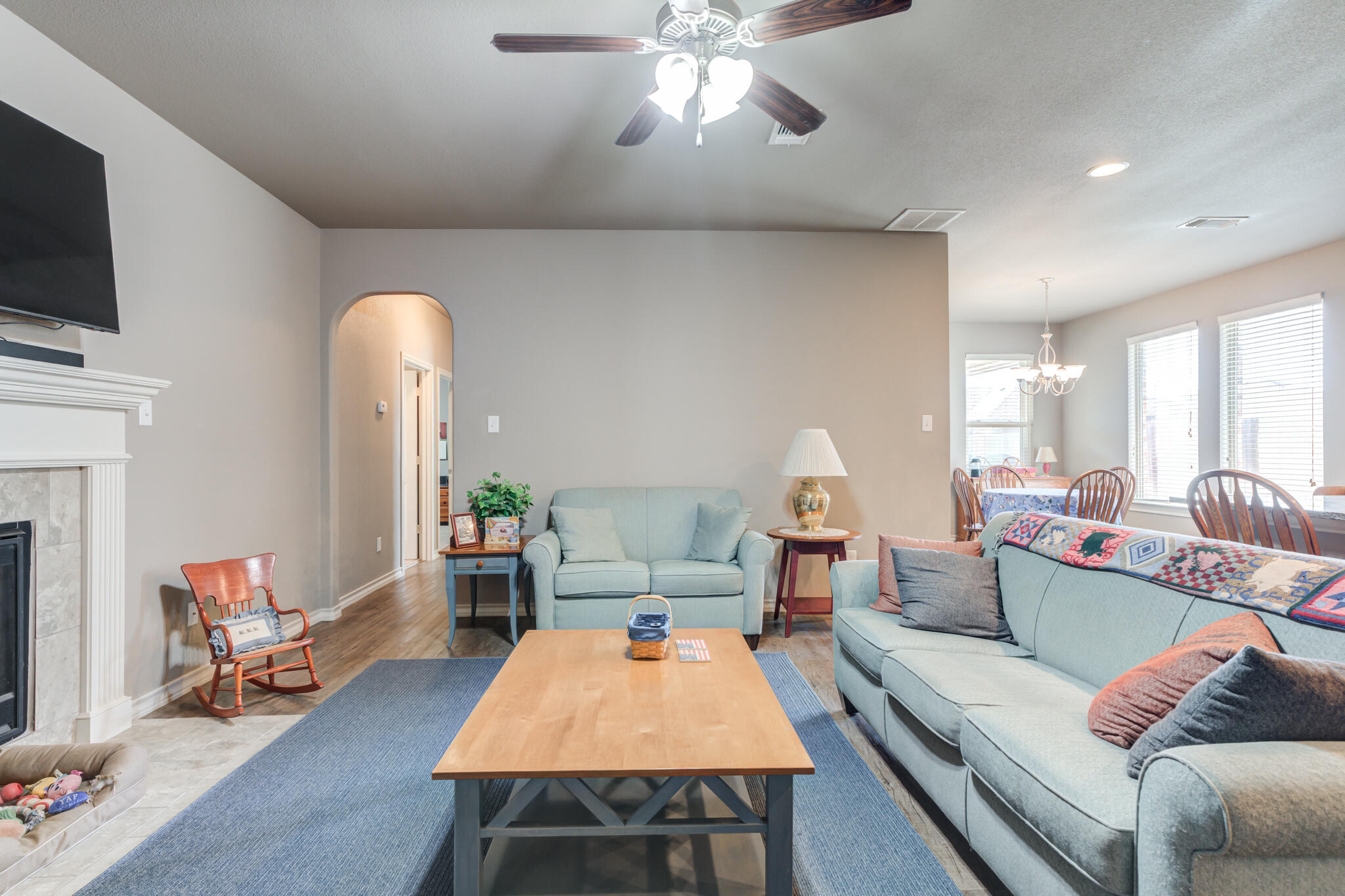 5219 Kemper Street Lubbock, TX 79416 - Photo 10 of 38 a living room with furniture and a flat screen tv