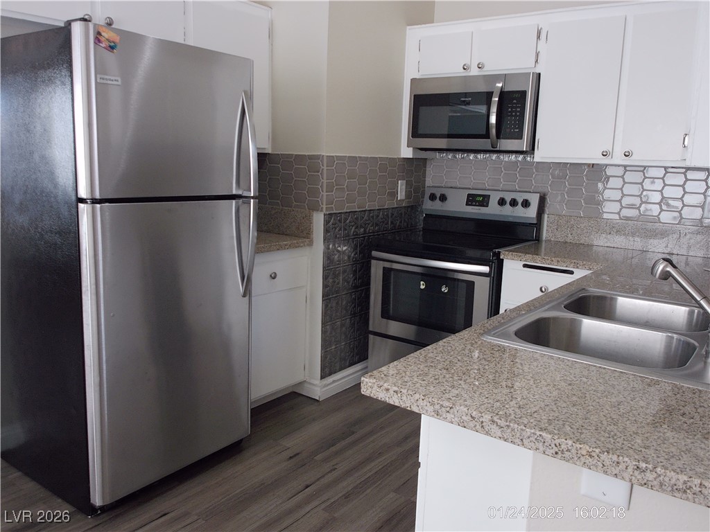 7313 Saybrook Point Drive Las Vegas, NV 89128 - Photo 11 of 31 Kitchen featuring stainless steel appliances and white cabinets