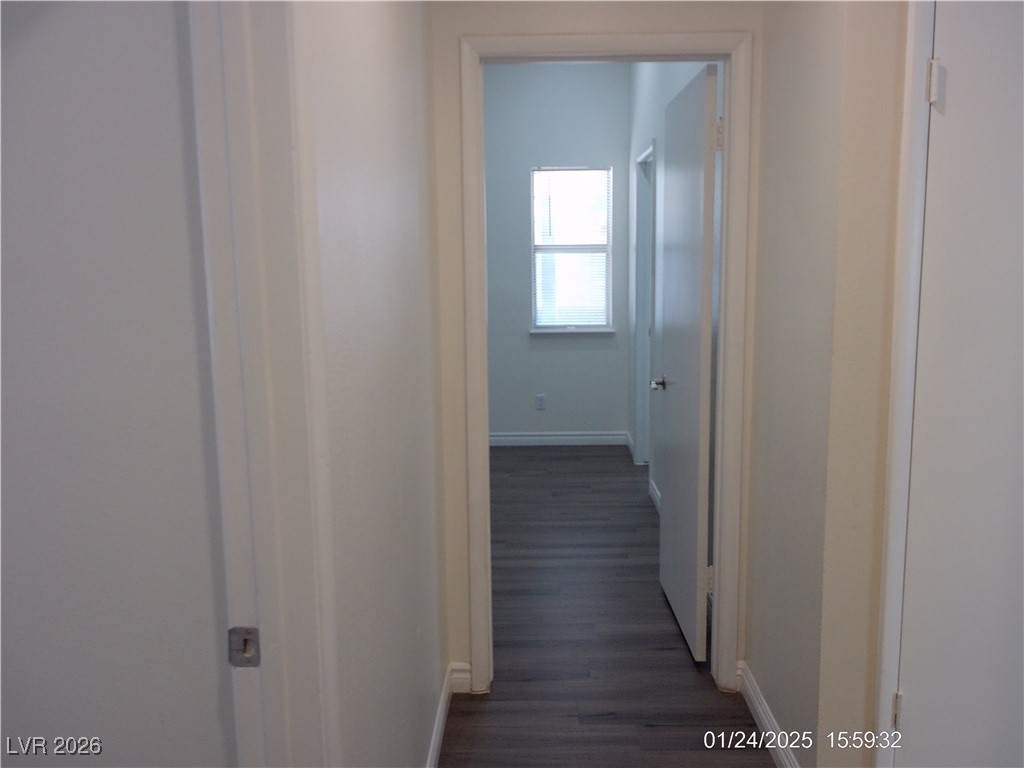 7313 Saybrook Point Drive Las Vegas, NV 89128 - Photo 19 of 31 Corridor with baseboards and dark wood finished floors