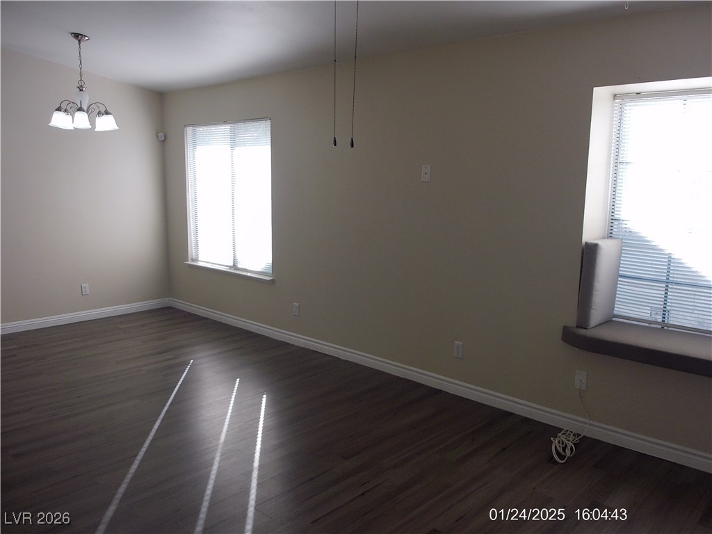 7313 Saybrook Point Drive Las Vegas, NV 89128 - Photo 4 of 31 Unfurnished dining area with dark wood finished floors and baseboards