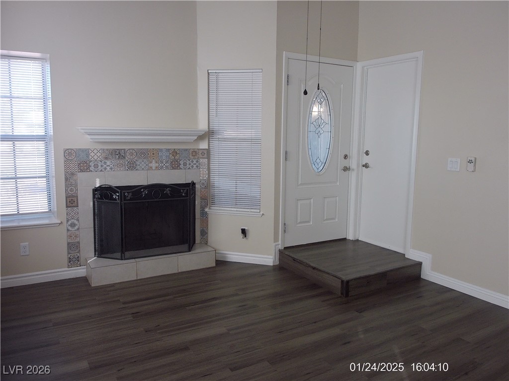 7313 Saybrook Point Drive Las Vegas, NV 89128 - Photo 5 of 31 Foyer entrance featuring dark wood-type flooring and a tiled fireplace