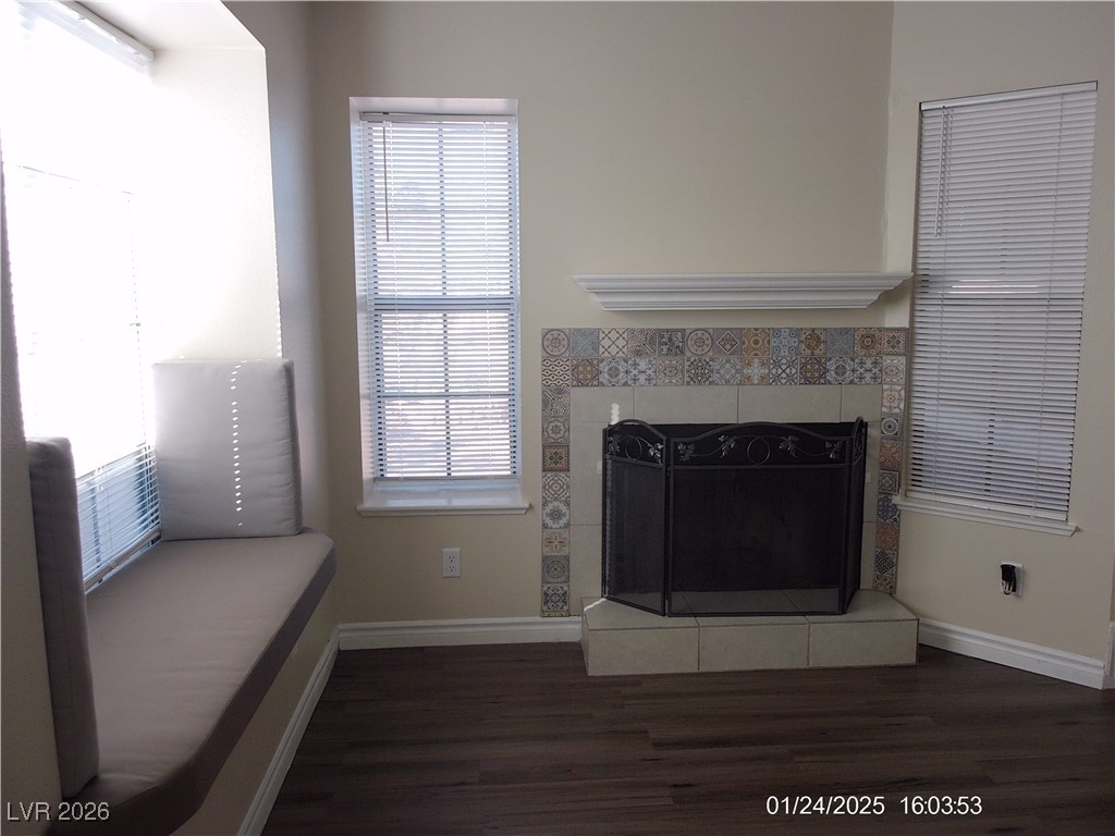 7313 Saybrook Point Drive Las Vegas, NV 89128 - Photo 6 of 31 Living area featuring dark wood finished floors and a tiled fireplace