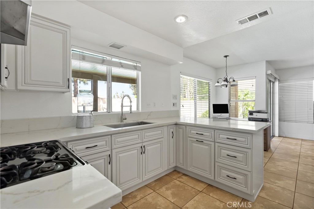 9321 Loquat Drive Riverside, CA 92508 - Photo 11 of 39 a kitchen with a stove a sink and a refrigerator