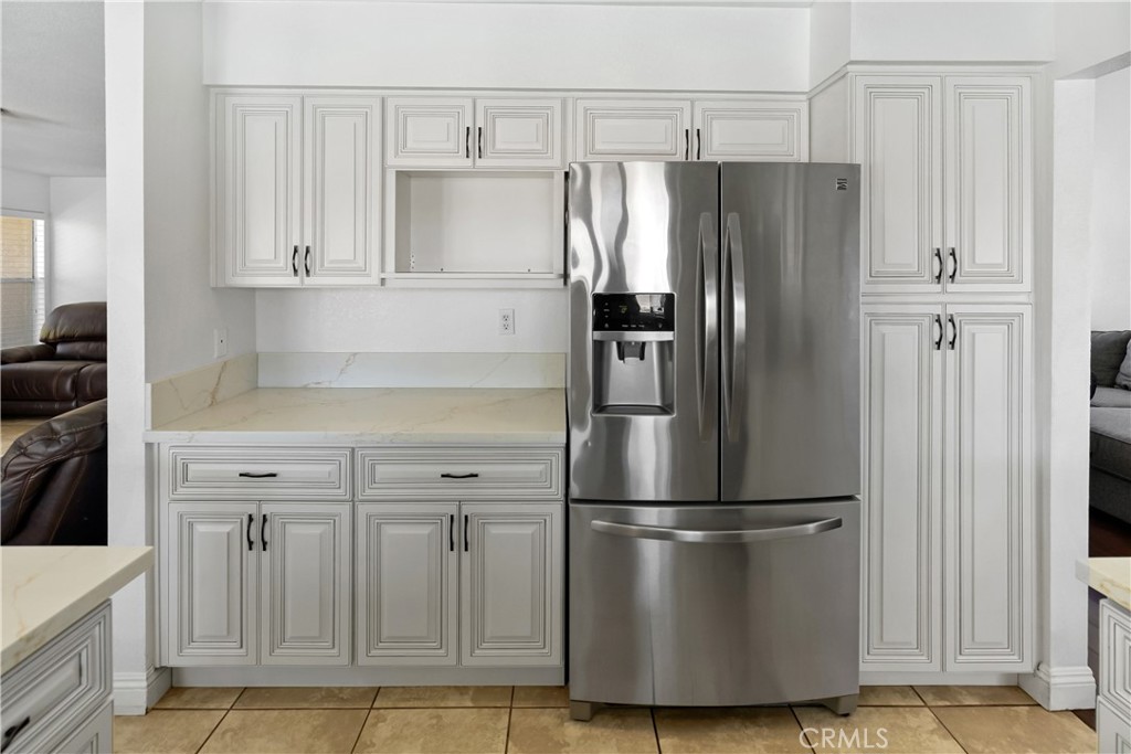 9321 Loquat Drive Riverside, CA 92508 - Photo 12 of 39 a metallic refrigerator freezer sitting in a kitchen
