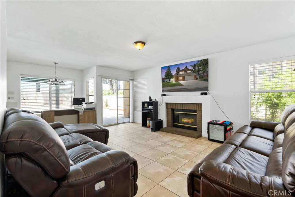 9321 Loquat Drive Riverside, CA 92508 - Photo 13 of 39 a living room with furniture a fireplace and a large window