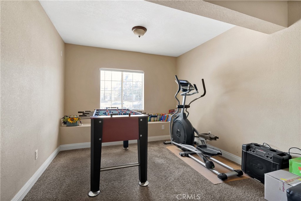 9321 Loquat Drive Riverside, CA 92508 - Photo 18 of 39 a room with gym equipment and windows