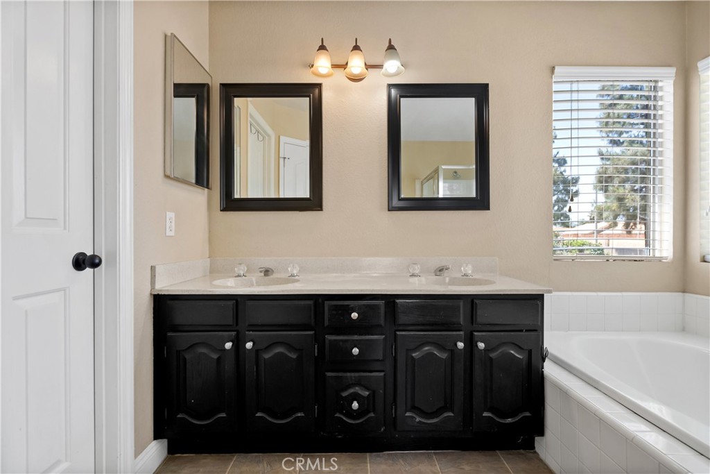9321 Loquat Drive Riverside, CA 92508 - Photo 24 of 39 a bathroom with a sink and a mirror
