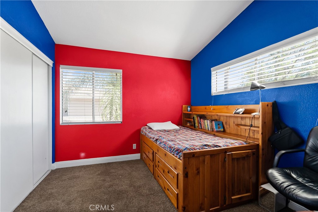 9321 Loquat Drive Riverside, CA 92508 - Photo 29 of 39 a bedroom with a bed and wooden floor