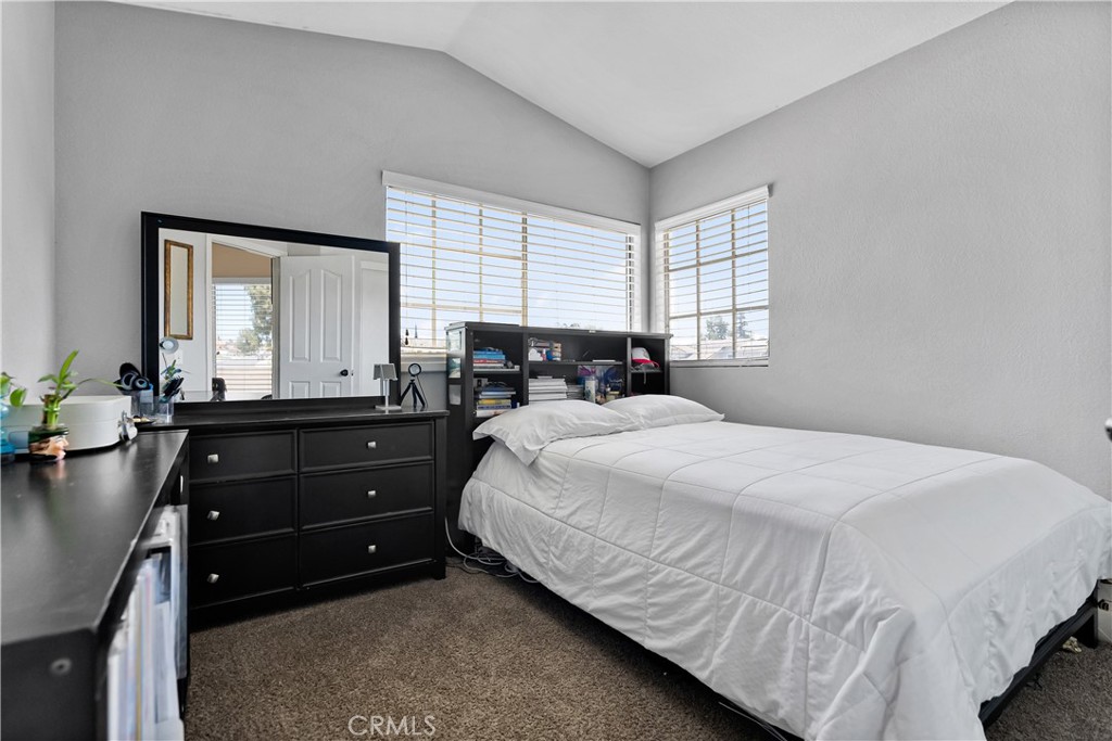 9321 Loquat Drive Riverside, CA 92508 - Photo 30 of 39 a bedroom with a bed and window