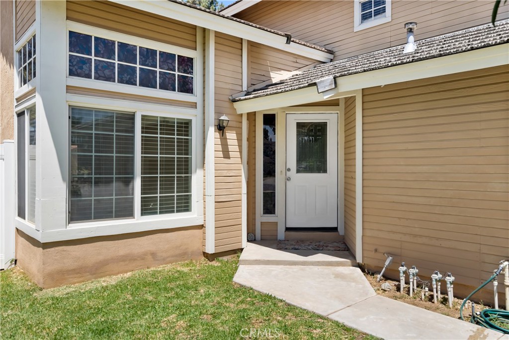 9321 Loquat Drive Riverside, CA 92508 - Photo 5 of 39 a front view of a house with a yard