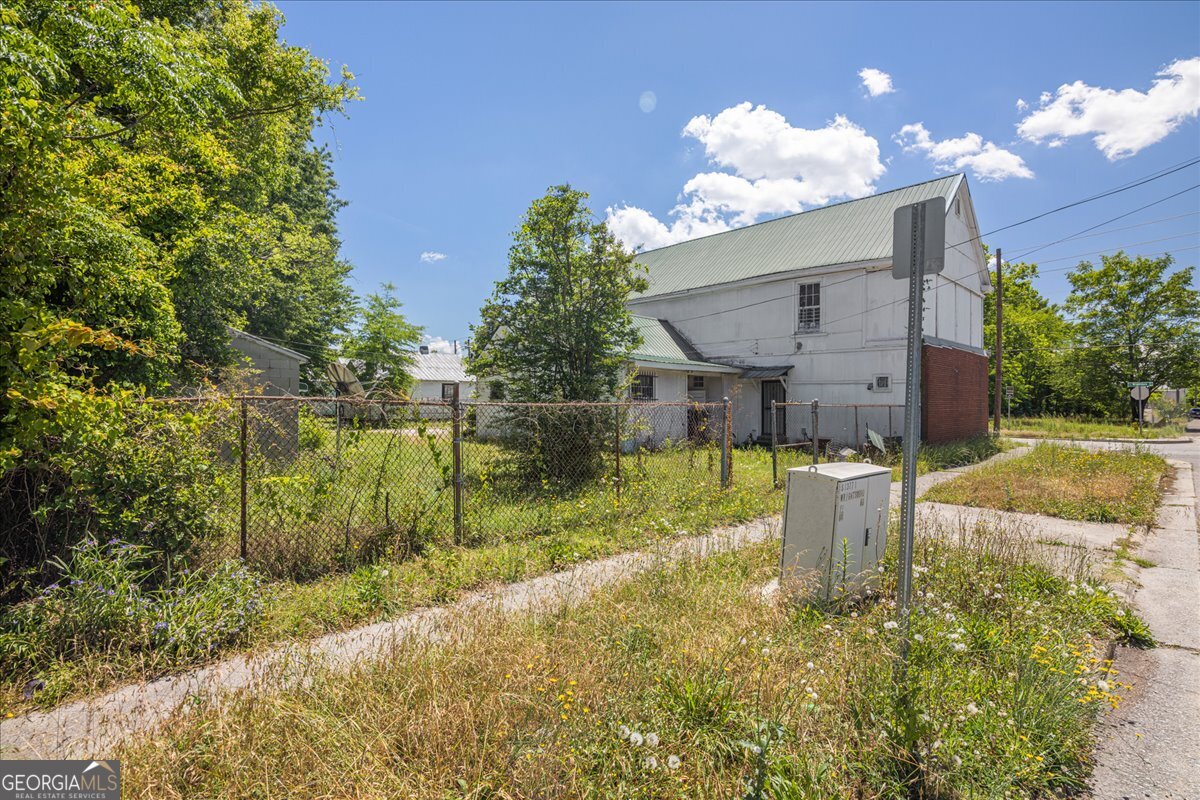 1367 Wrightsboro Road Augusta, GA 30901 - Photo 11 of 49 a swimming pool with outdoor seating and yard