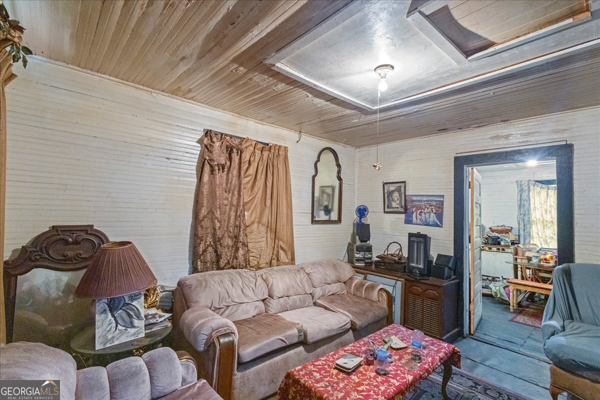 1367 Wrightsboro Road Augusta, GA 30901 - Photo 20 of 49 a living room with furniture and a chandelier